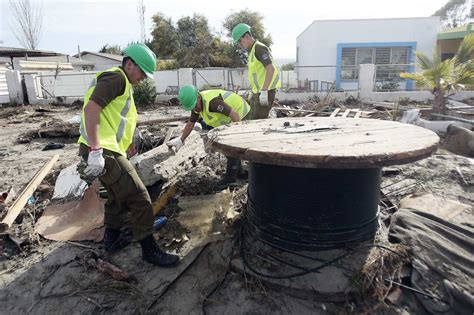 cleaning mud Chile|Residents clear mud, rubble as rebuilding begins after Chile .